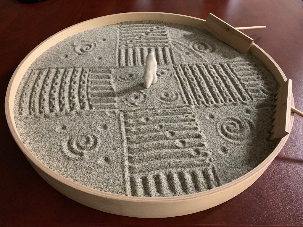Hand-built Zen garden with raked sand and placed rock